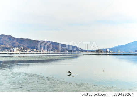 Lake Suwa is frozen over. Lake Suwa is frozen over. 139486264