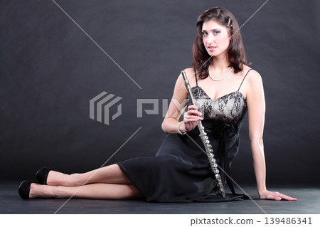 girl and flute on a black background 139486341