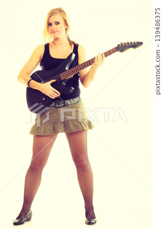Woman artist player with electric guitar. Woman artist player with electric guitar. 139486375