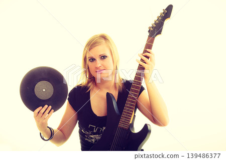 Woman with electrical guitar and vinyl record. Woman with electrical guitar and vinyl record. 139486377