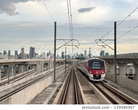 Modern SRT Red Line Commuter Train on Elevated Tracks with Bangkok Skyline Background Modern SRT Red Line Commuter Train on Elevated Tracks with Bangkok Skyline Background 139486987