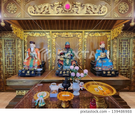 Ornate Chinese Altar with Guan Yu and Deity Statues on Golden Shrine Ornate Chinese Altar with Guan Yu and Deity Statues on Golden Shrine 139486988