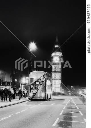 London in winter: Elizabeth Tower (Big Ben) and a double-decker bus illuminated at night (monochrome). 139487453