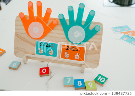 Wooden math board with colorful counters and numbers. Designed for interactive learning and developing counting skills in children. Wooden math board with colorful counters and numbers. Designed for interactive learning and developing counting skills in children. 139487725