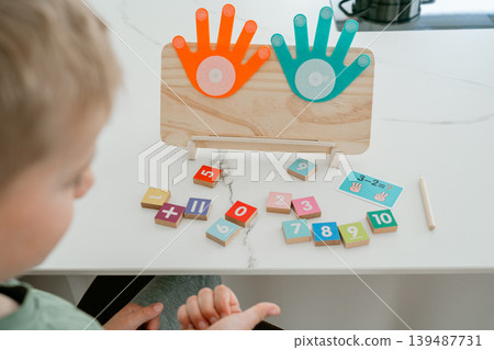 Math learning setup with colorful number blocks and counting board. Designed for early education and interactive teaching. Math learning setup with colorful number blocks and counting board. Designed for early education and interactive teaching. 139487731