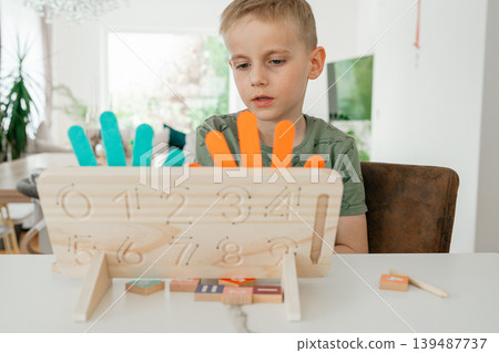Educational toy designed for learning numbers and addition. The image highlights creative teaching methods for children. 139487737