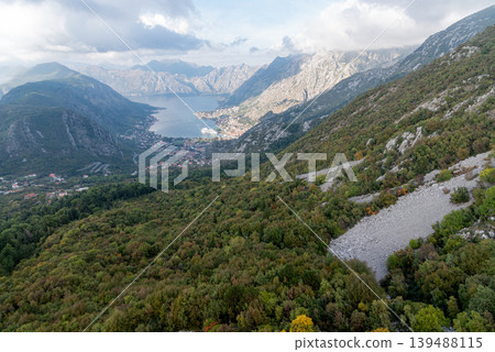 View from cable car to Boka Kotor Bay, large tourist liner parked among mountain View from cable car to Boka Kotor Bay, large tourist liner parked among mountain 139488115