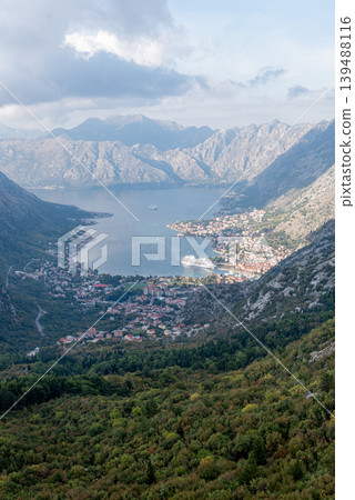 View from cable car to Boka Kotor Bay, large tourist liner parked among mountain View from cable car to Boka Kotor Bay, large tourist liner parked among mountain 139488116