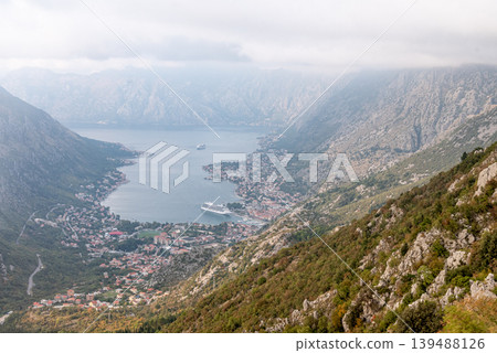 View from cable car to Boka Kotor Bay, large tourist liner parked among mountain View from cable car to Boka Kotor Bay, large tourist liner parked among mountain 139488126