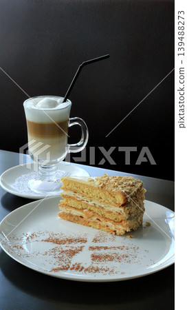 Piece of sweet napoleon cake served with cappuccino detailed photo Piece of sweet napoleon cake served with cappuccino detailed photo 139488273