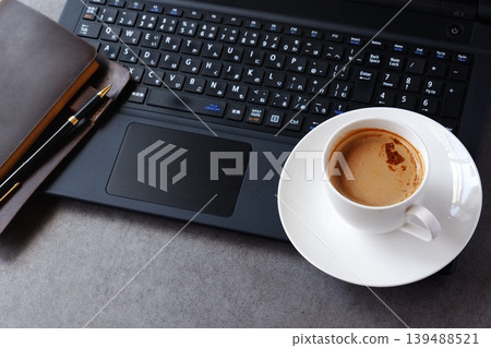 Computer and Coffee - Image of working at a desk with a laptop while drinking freshly brewed coffee Computer and Coffee - Image of working at a desk with a laptop while drinking freshly brewed coffee 139488521