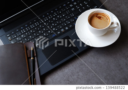 Computer and Coffee - Image of working at a desk with a laptop while drinking freshly brewed coffee Computer and Coffee - Image of working at a desk with a laptop while drinking freshly brewed coffee 139488522