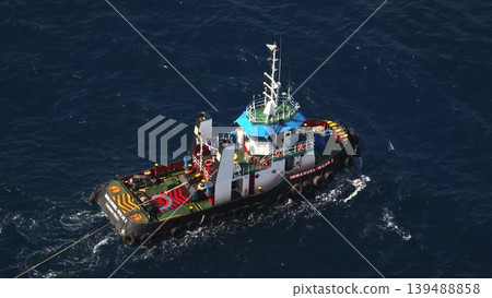 2023.06.10 - Indonesia, Bali: Tugboat Immanuel WGSR 2 navigates a calm ocean, engaged in a towing operation, demonstrating essential maritime logistics and assistance at sea from an aerial perspective 139488858