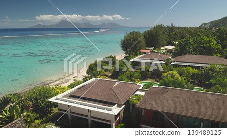 Breathtaking aerial view of Tahiti island luxury resort hotels with swimming pool, pristine white sand beach and crystal clear turquoise coral reef lagoon. Remote nature paradise, exotic summer travel Breathtaking aerial view of Tahiti island luxury resort hotels with swimming pool, pristine white sand beach and crystal clear turquoise coral reef lagoon. Remote nature paradise, exotic summer travel 139489125