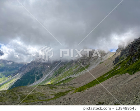 Alpine peaks and green valleys under clouds, Les Contamines-Montjoie, France Alpine peaks and green valleys under clouds, Les Contamines-Montjoie, France 139489543