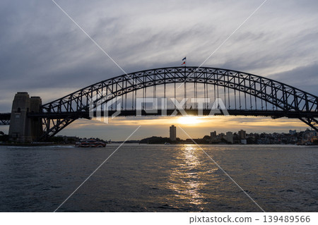 Sydney Harbour Bridge at sunset with golden reflections on the water Sydney Harbour Bridge at sunset with golden reflections on the water 139489566