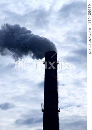 Clouds of toxic smoke from smokestack over clouds at the sky Clouds of toxic smoke from smokestack over clouds at the sky 139489689
