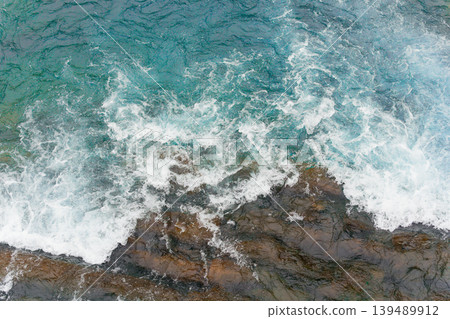Aerial View of Rocky Coastline with Crashing Turquoise Waves 139489912