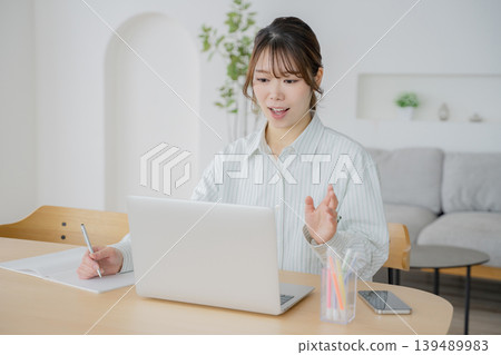 A woman talking to a computer screen A woman talking to a computer screen 139489983