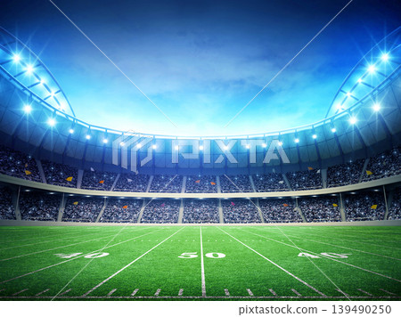 Illuminated American Football Field at Night in a Stadium 139490250