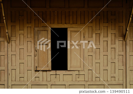 thai style woody wall with window made from a plank of wood 139490511