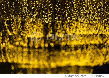 many bokeh from light bulb tubes on a street at night look like luxury golden starlight in a dark background 139490529