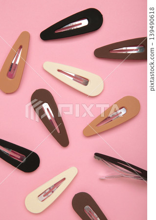 Colored pastel hair clips on pink background. Vertical photo Colored pastel hair clips on pink background. Vertical photo 139490618