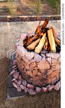Stone fire pit in the backyard. Vertical photo Stone fire pit in the backyard. Vertical photo 139490648