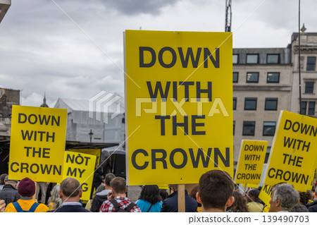 Anti-monarchy protesters holding yellow Down with the Crown signs Anti-monarchy protesters holding yellow Down with the Crown signs 139490703