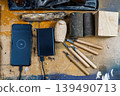 Carpenter's workbench with carving tools and a smartphone charging from a power bank. 139490713