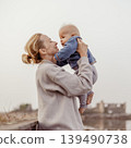 Tender woman caressing her little baby boy infant child outdoors on autumn trip to Secovlje salinas landscape park, Slovenia. Mother's unconditional love for her child 139490738