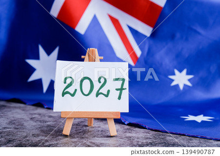 Australian flag and text 2027 trendy template for upcoming year campaigns. Patriotic design marking 2027 beside national flag. Concept of future vision and planning ideal for annual report or goal Australian flag and text 2027 trendy template for upcoming year campaigns. Patriotic design marking 2027 beside national flag. Concept of future vision and planning ideal for annual report or goal 139490787