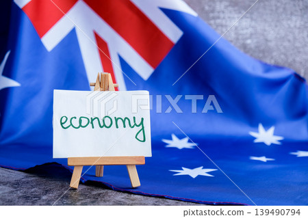 Australian flag with message text ECONOMY for finance or analysis. National theme and economic. Concept of fiscal trends and national growth use for reports Australian flag with message text ECONOMY for finance or analysis. National theme and economic. Concept of fiscal trends and national growth use for reports 139490794