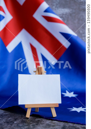 Mock-up for custom copy designs. Clean empty message board next to Australian flag. Place your logo or text on the white paper board next to the Australian flag. Modern mock-up template with national 139490800