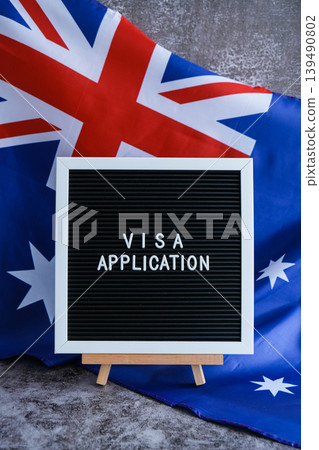 Text VISA APPLICATION on background of waving Australian flag made from silk. Concept of tourism and traveling. Inviting greeting card, advertisement 139490802