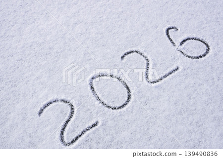 Written sketch for new year 2026. Snow background numbers ice outdoor on ground in winter. Writing text sign and drawing on field in nature frozen background. Copy space 139490836