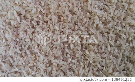 Close up of the texture of raw white rice grains Close up of the texture of raw white rice grains 139491235