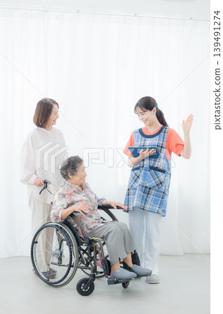 Elderly person in a wheelchair receiving care 139491274