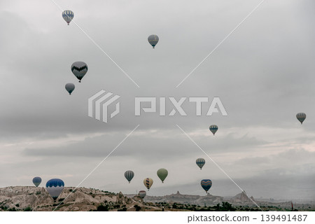 Air balloon flight early morning dawn cloudy sky mountain rock Cappadocia Turkey Air balloon flight early morning dawn cloudy sky mountain rock Cappadocia Turkey 139491487