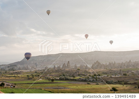 Air balloon flight early morning dawn cloudy sky mountain rock Cappadocia Turkey Air balloon flight early morning dawn cloudy sky mountain rock Cappadocia Turkey 139491489