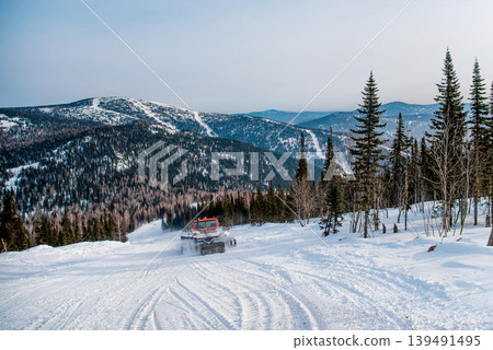 Snowcat cleans ski track at ski resort in winter Sheregesh, Siberia, Russia 139491495