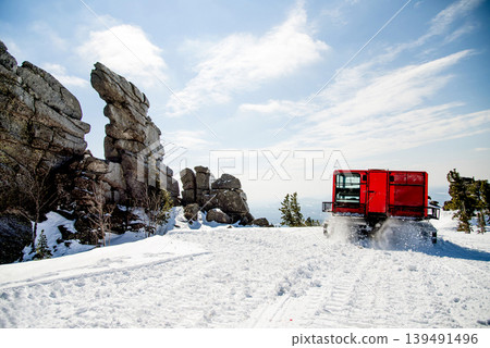 Snowcat cleans ski track at ski resort in winter Sheregesh, Siberia, Russia 139491496