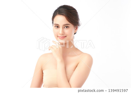 A beautiful young Asian woman with clean, fresh skin against a white background. Skincare, facial treatment, cosmetology, beauty, and spa. An elegant portrait of an Asian woman. A beautiful young Asian woman with clean, fresh skin against a white background. Skincare, facial treatment, cosmetology, beauty, and spa. An elegant portrait of an Asian woman. 139491597
