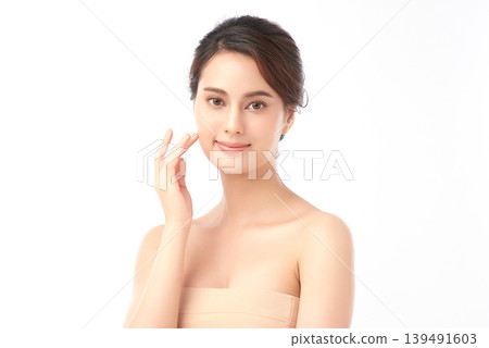 A beautiful young Asian woman with clean, fresh skin against a white background. Skincare, facial treatment, cosmetology, beauty, and spa. An elegant portrait of an Asian woman. 139491603
