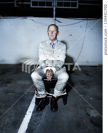 Man, business and rope kidnapping or scared corporate professional for ransom, hostage or criminal terror. Male person, chair and tied up for mafia abduction or robber victim, gangster or parking lot Man, business and rope kidnapping or scared corporate professional for ransom, hostage or criminal terror. Male person, chair and tied up for mafia abduction or robber victim, gangster or parking lot 139491700