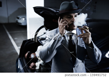 Mafia, car and man with hostage in trunk for negotiation, kidnapping ransom and crime. Business, gangster criminal smoking and person in boot for abduction, danger and robbery in parking lot or smoke Mafia, car and man with hostage in trunk for negotiation, kidnapping ransom and crime. Business, gangster criminal smoking and person in boot for abduction, danger and robbery in parking lot or smoke 139491732