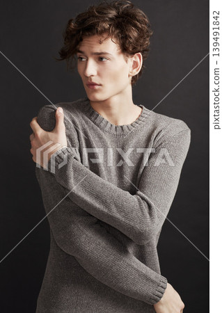 Serious, fashion and man in sweater thinking in studio isolated on a a grey background. Model, idea and dream in style, trendy clothes and young, handsome or casual insecure person on a backdrop Serious, fashion and man in sweater thinking in studio isolated on a a grey background. Model, idea and dream in style, trendy clothes and young, handsome or casual insecure person on a backdrop 139491842