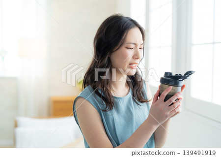  Woman drinking protein 139491919