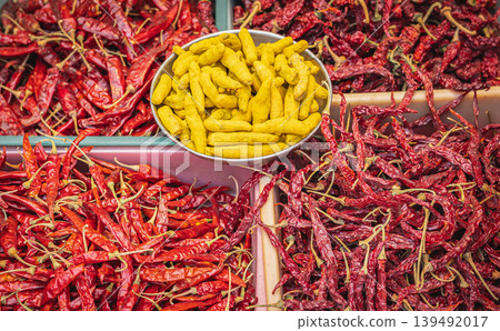 Turmeric roots and dry red chili spices for sale on a spice market. Fresh ingredients for cooking 139492017