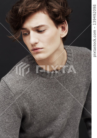 Thinking, serious and man in sweater for fashion in studio isolated on a a black background. Model in jersey with idea, .style and trendy clothes of young, handsome or casual person on a backdrop Thinking, serious and man in sweater for fashion in studio isolated on a a black background. Model in jersey with idea, .style and trendy clothes of young, handsome or casual person on a backdrop 139492098